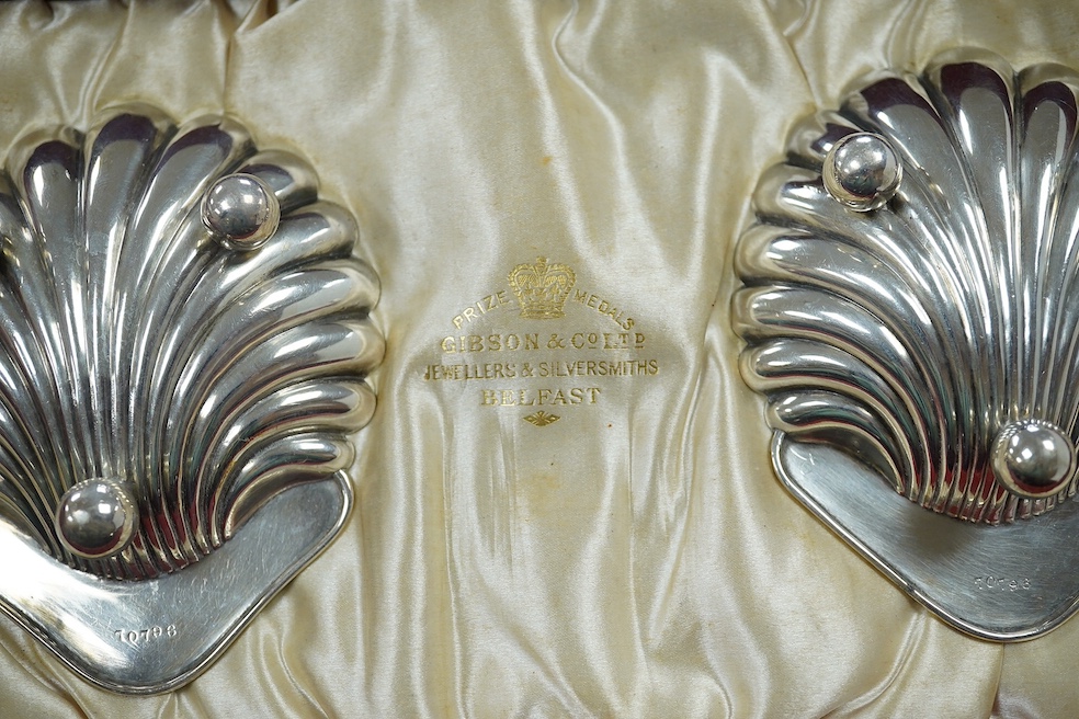 A cased pair of late Victorian silver butter shells with matching butter knives, Horace Woodward & Co Ltd, London, 1897, 95mm. Condition - good